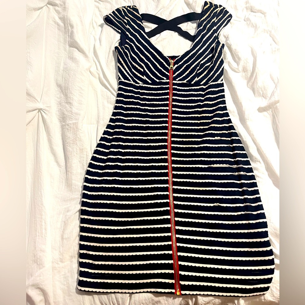 Guess mini dress with cross back detail and zipper in the front. Fair condition.